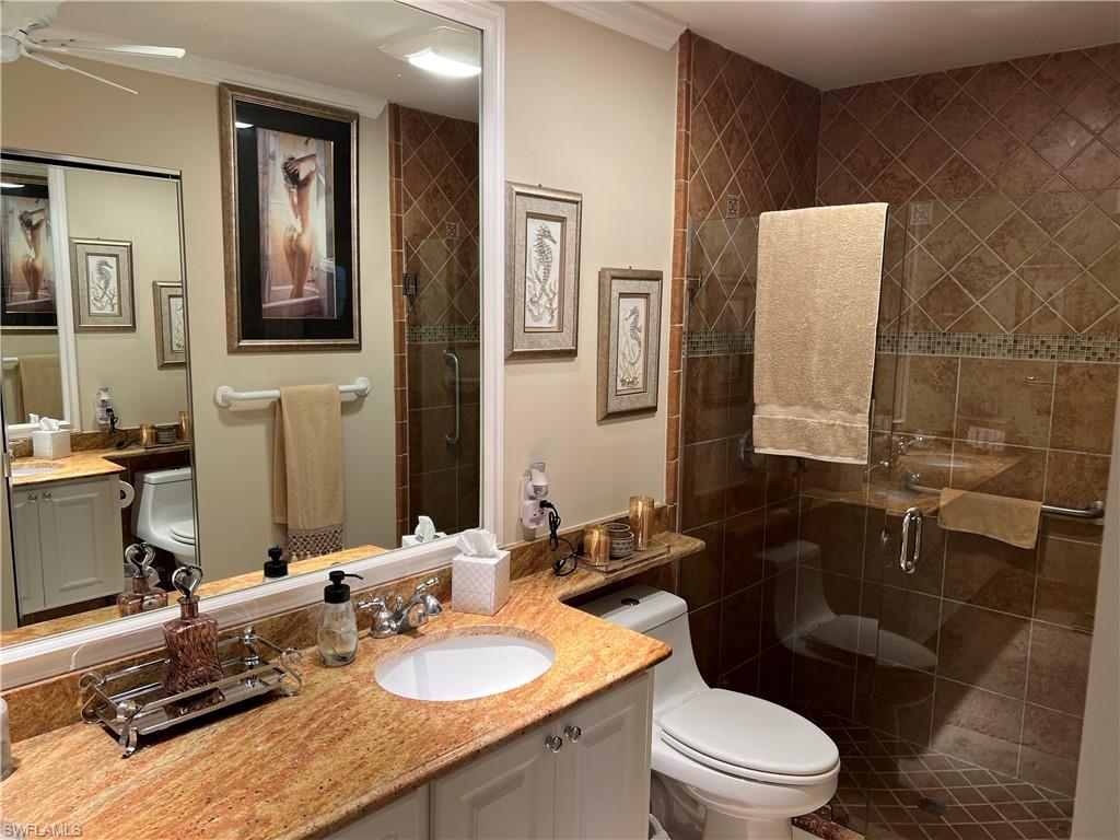 5433 Guadeloupe Way Naples, FL 34119 - Photo 12 of 16 a bathroom with a granite countertop sink mirror and toilet
