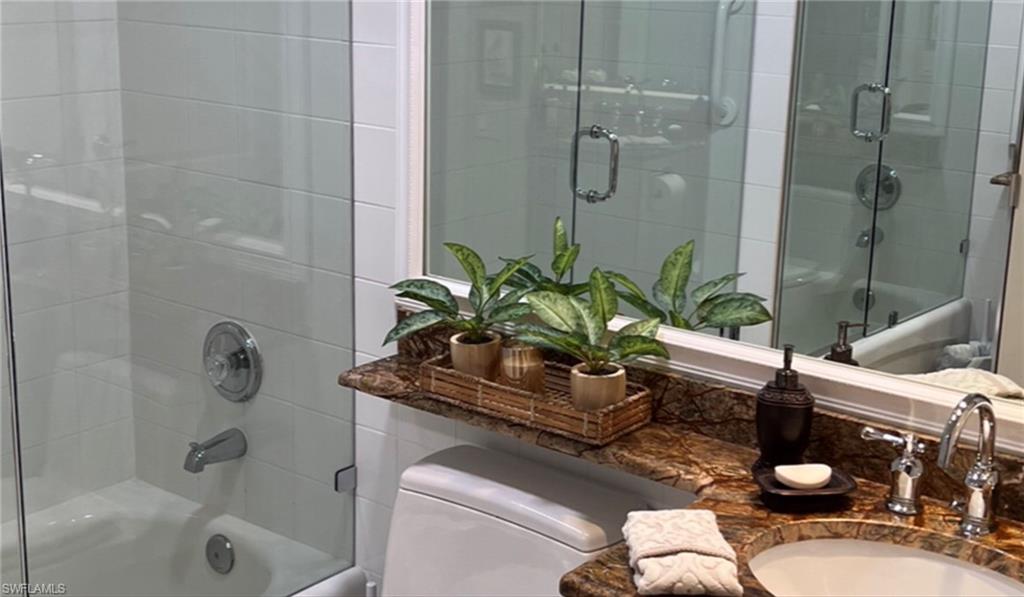 5433 Guadeloupe Way Naples, FL 34119 - Photo 14 of 16 a bath room with a toilet and a bath tub