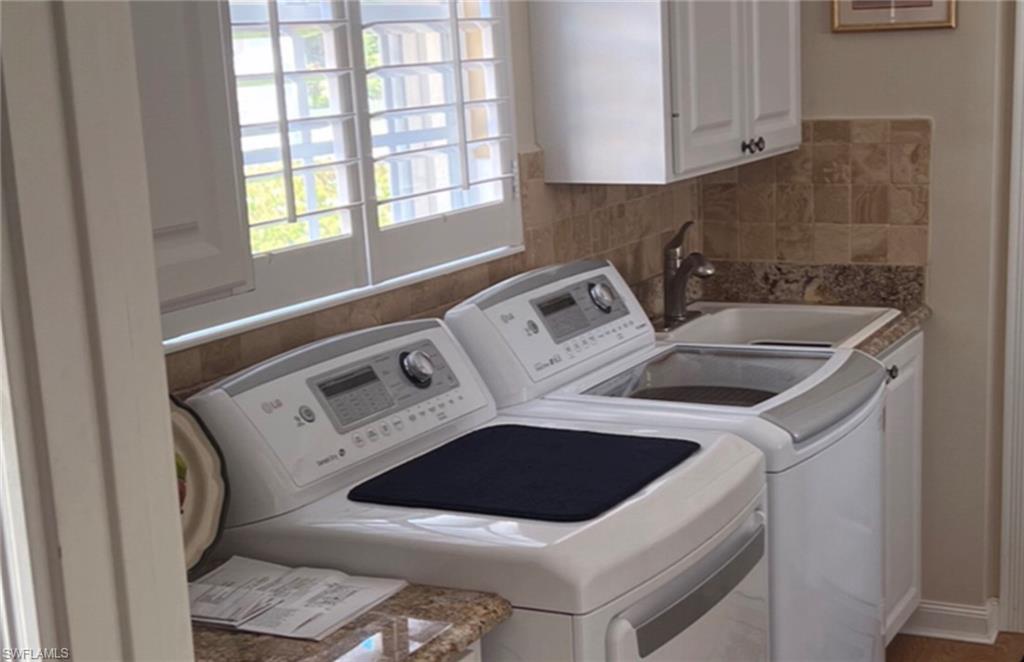 5433 Guadeloupe Way Naples, FL 34119 - Photo 3 of 16 a utility room with dryer and washer