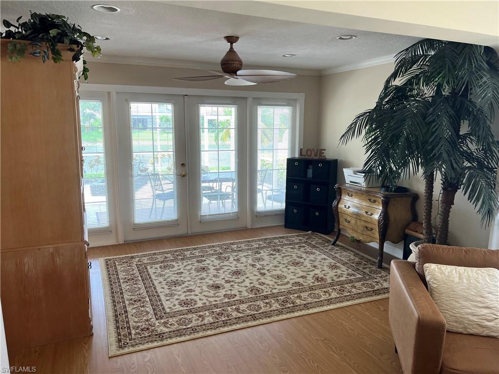 5433 Guadeloupe Way Naples, FL 34119 - Photo 8 of 16 wooden floor in an empty room with a window