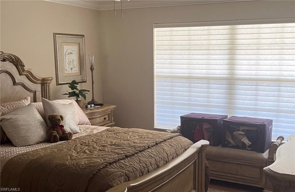 5433 Guadeloupe Way Naples, FL 34119 - Photo 10 of 16 a bedroom with a bed and wooden floor