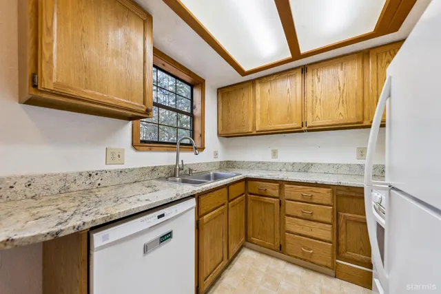 a kitchen with granite countertop stainless steel appliances stove and cabinets