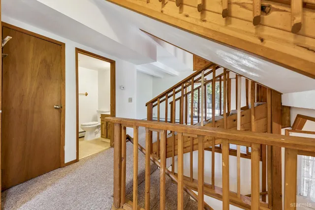 a bathroom with a sink mirror and toilet