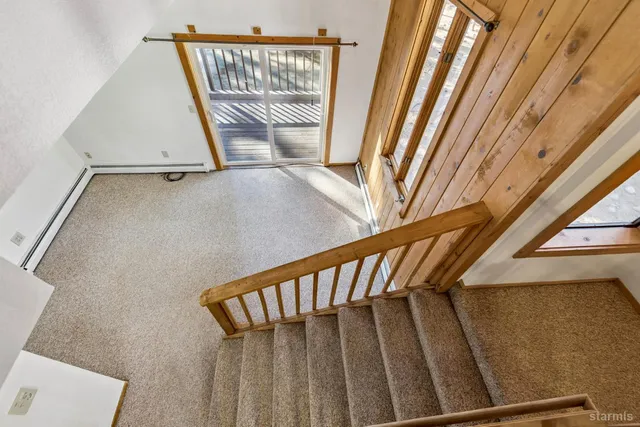 a view of staircase with a rug