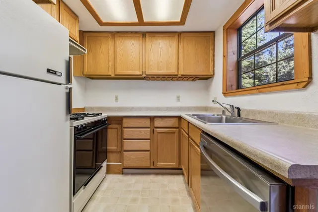 a kitchen that has a sink and a stove