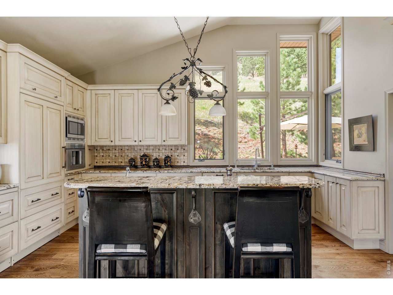 86 South Cedar Brook Road Boulder, CO 80304 - Photo 10 of 40 a kitchen with stainless steel appliances granite countertop a stove a sink dishwasher and cabinets with wooden floor