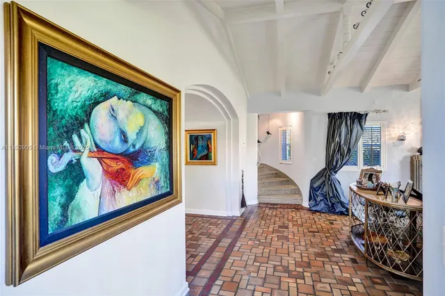 a room with lots of painting and a rug