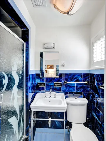 a bathroom with a sink toilet and mirror