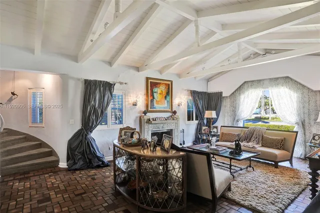 a living room with furniture a fireplace and a table