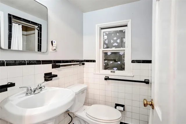 a bathroom with a sink mirror and toilet