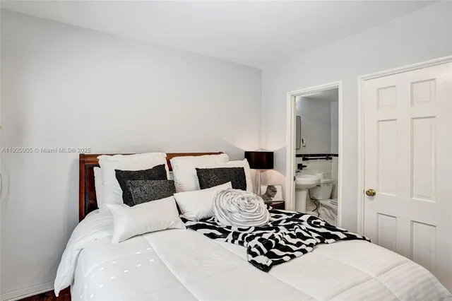 a bedroom with a bed and a lamp