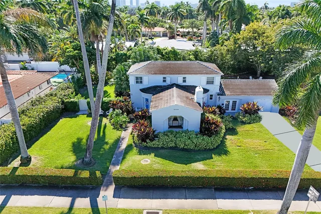 an aerial view of a house with a yard basket ball court and outdoor seating