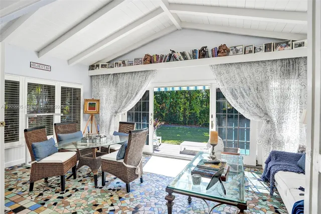a living room with furniture and a floor to ceiling window