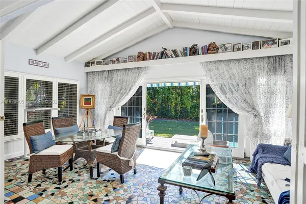 a living room with furniture and a floor to ceiling window