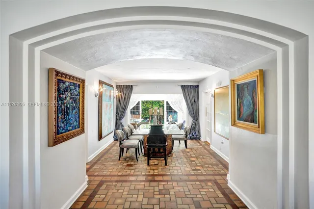 a dining room with wooden floor and a rug