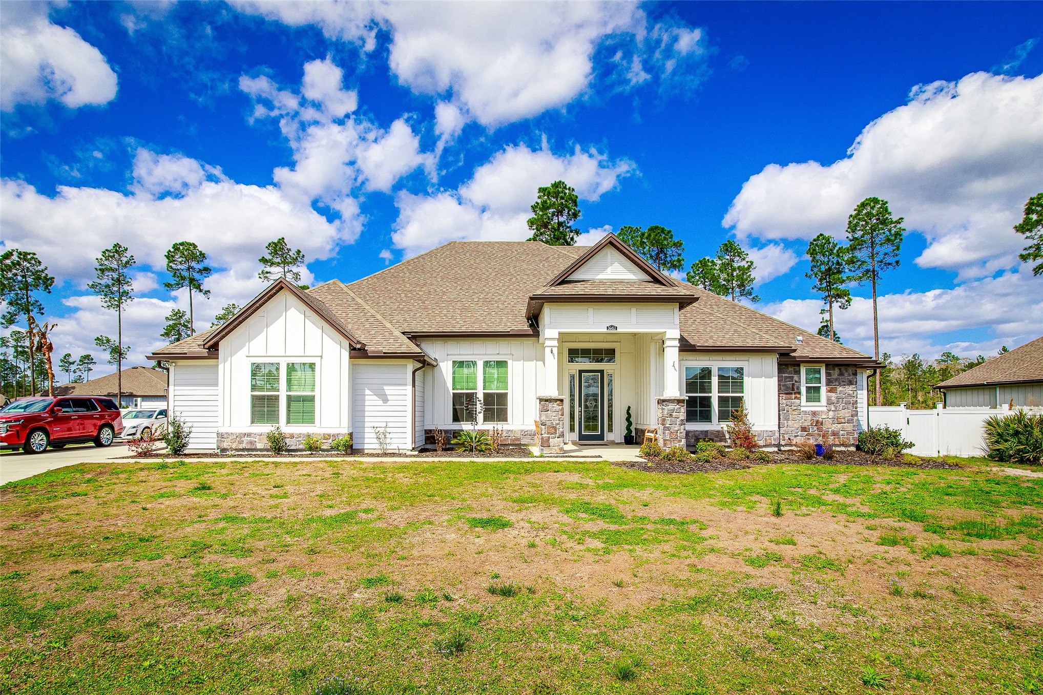 36453 Shortleaf Avenue Hilliard, FL 32046 - Photo 2 of 29 a front view of a house with a yard table and chairs