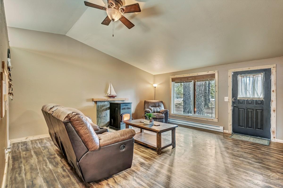 59757 Cheyenne Road Bend, OR 97702 - Photo 3 of 25 a living room with furniture and a floor to ceiling window