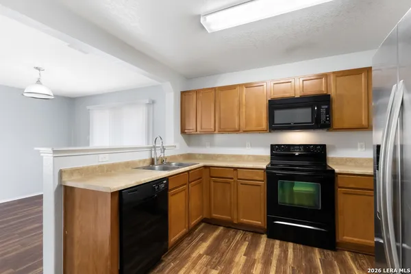 a kitchen with a sink stove and microwave