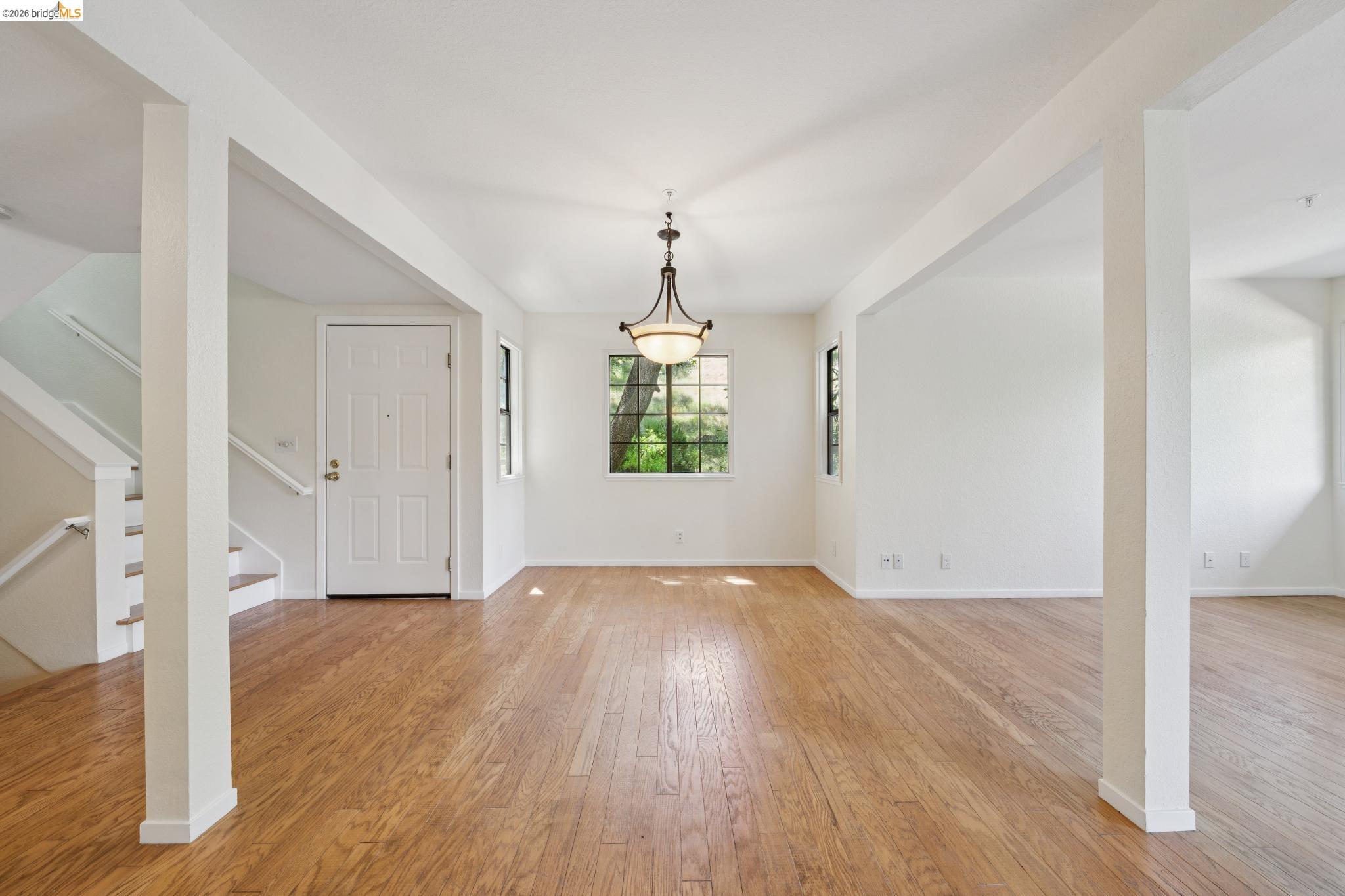 261 Redhawk Road Novato, CA 94949 - Photo 18 of 44 Spacious interior featuring wood-finish flooring, white walls, and a traditional chandelier