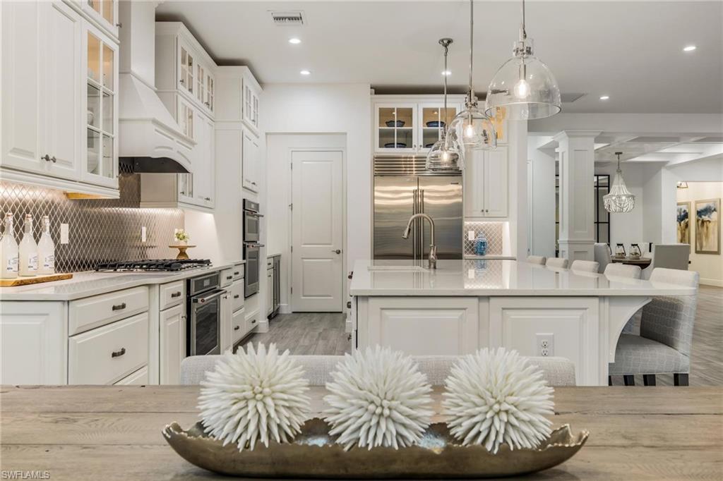 3664 Pilot Circle Naples, FL 34120 - Photo 11 of 35 a kitchen with stainless steel appliances granite countertop a stove a sink and a refrigerator