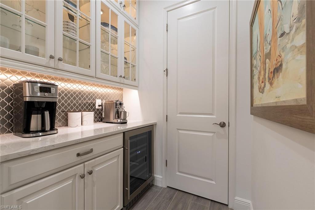 3664 Pilot Circle Naples, FL 34120 - Photo 16 of 35 a kitchen with a sink and cabinets