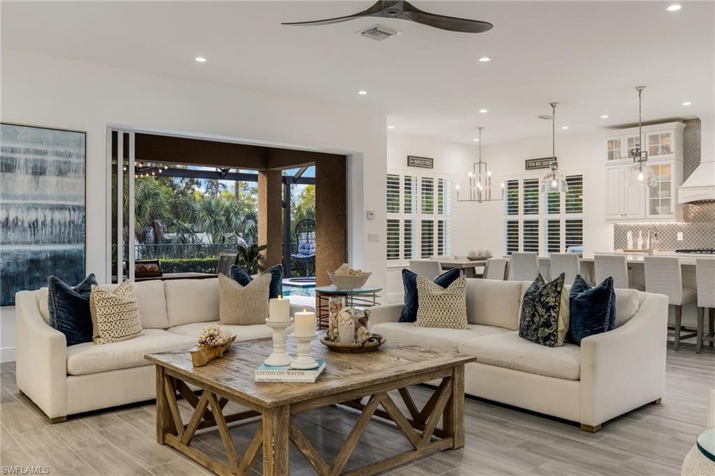 3664 Pilot Circle Naples, FL 34120 - Photo 18 of 35 a living room with furniture and a large window