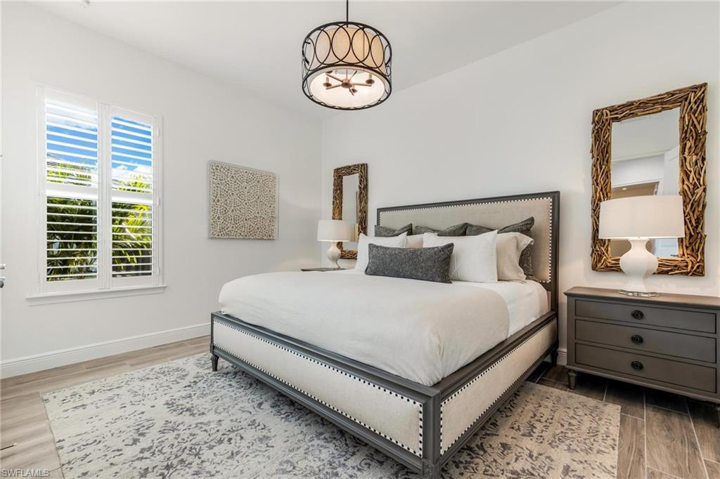 3664 Pilot Circle Naples, FL 34120 - Photo 19 of 35 a bedroom with a bed and window