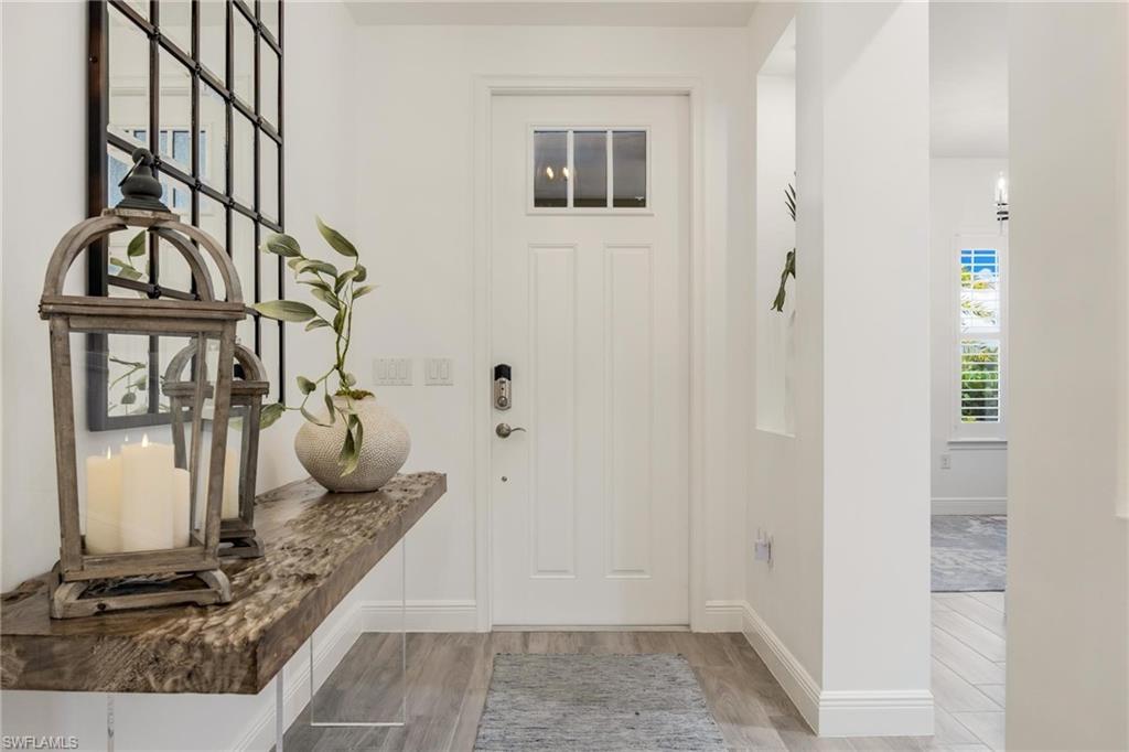 3664 Pilot Circle Naples, FL 34120 - Photo 2 of 35 a bathroom with a granite countertop sink and a mirror