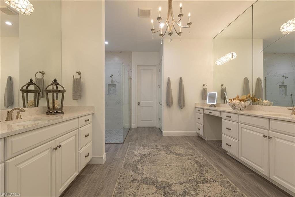 3664 Pilot Circle Naples, FL 34120 - Photo 26 of 35 a spacious bathroom with a granite countertop sink a toilet a mirror and vanity