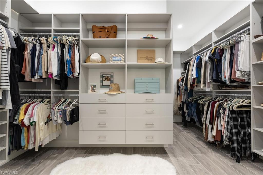 3664 Pilot Circle Naples, FL 34120 - Photo 29 of 35 a view of walk in closet with clothes and shoes
