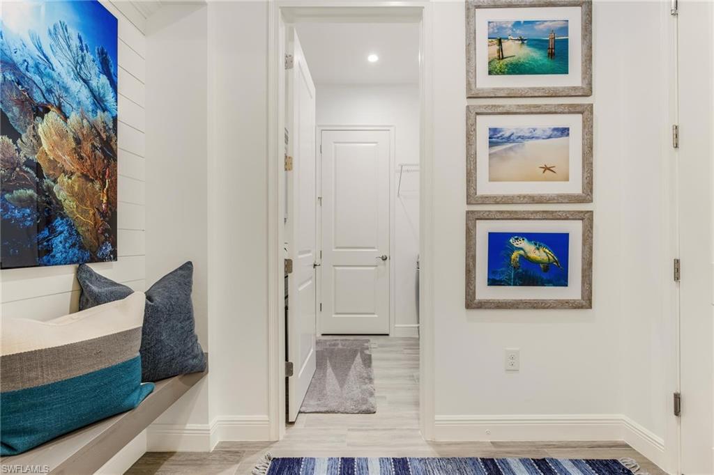 3664 Pilot Circle Naples, FL 34120 - Photo 3 of 35 a view of a hallway with wooden floor and dining room