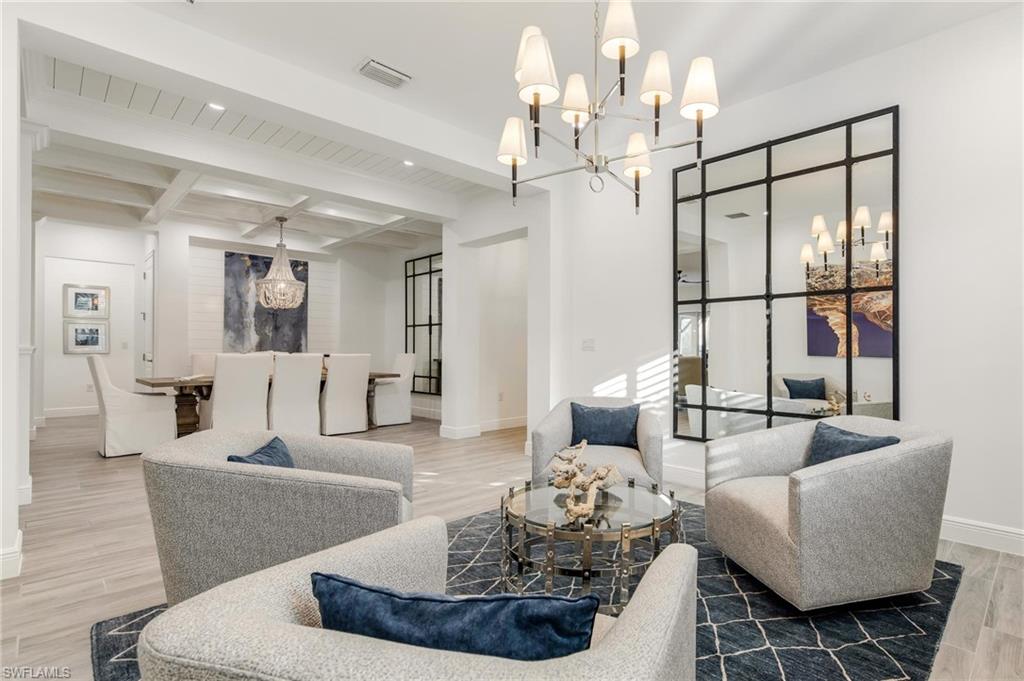 3664 Pilot Circle Naples, FL 34120 - Photo 6 of 35 a living room with furniture chandelier and a table
