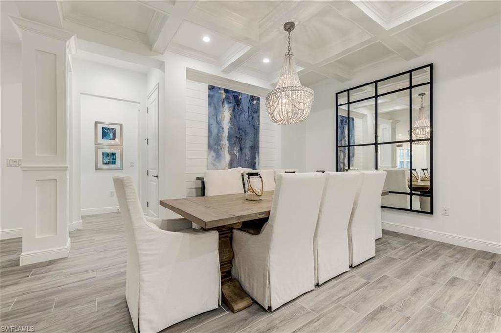 3664 Pilot Circle Naples, FL 34120 - Photo 8 of 35 a living room with furniture a table and wooden floor