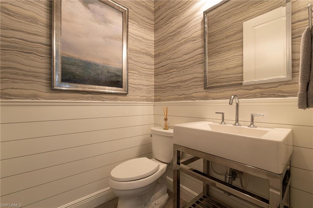 3664 Pilot Circle Naples, FL 34120 - Photo 9 of 35 a bathroom with a toilet a sink and mirror