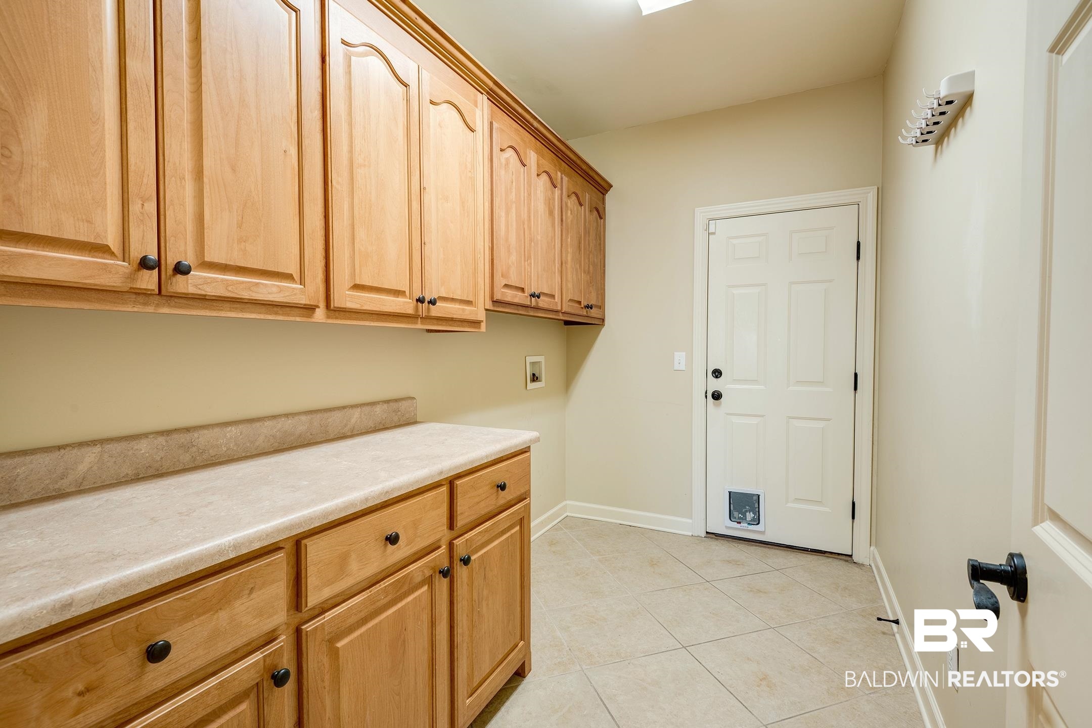 9421 Collier Loop Daphne, AL 36526 - Photo 21 of 31 Laundry area with cabinet space, hookup for a washing machine, and light tile patterned floors