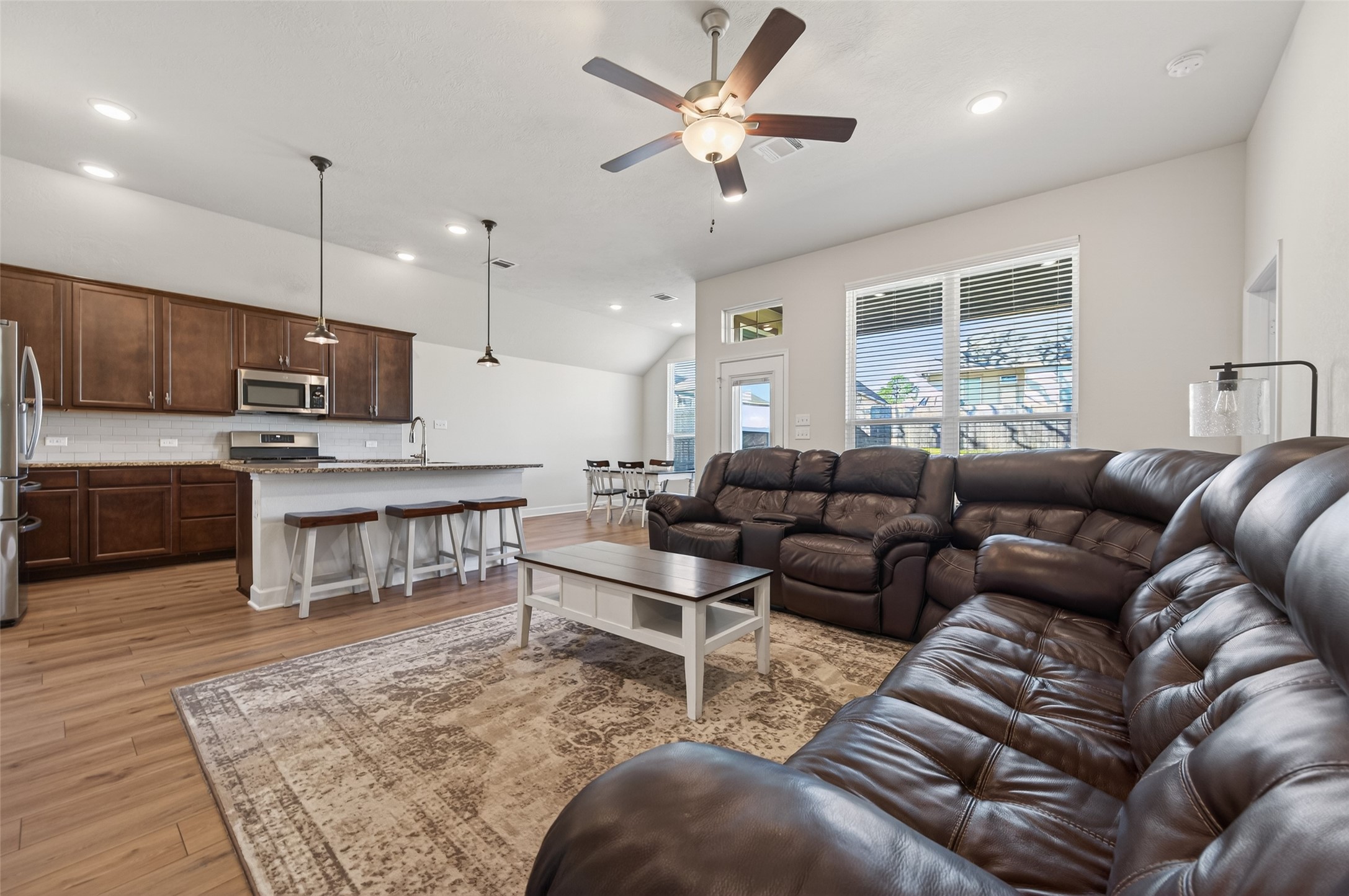 917 Farm Path Brenham, TX 77833 - Photo 6 of 43 a living room with furniture and kitchen view