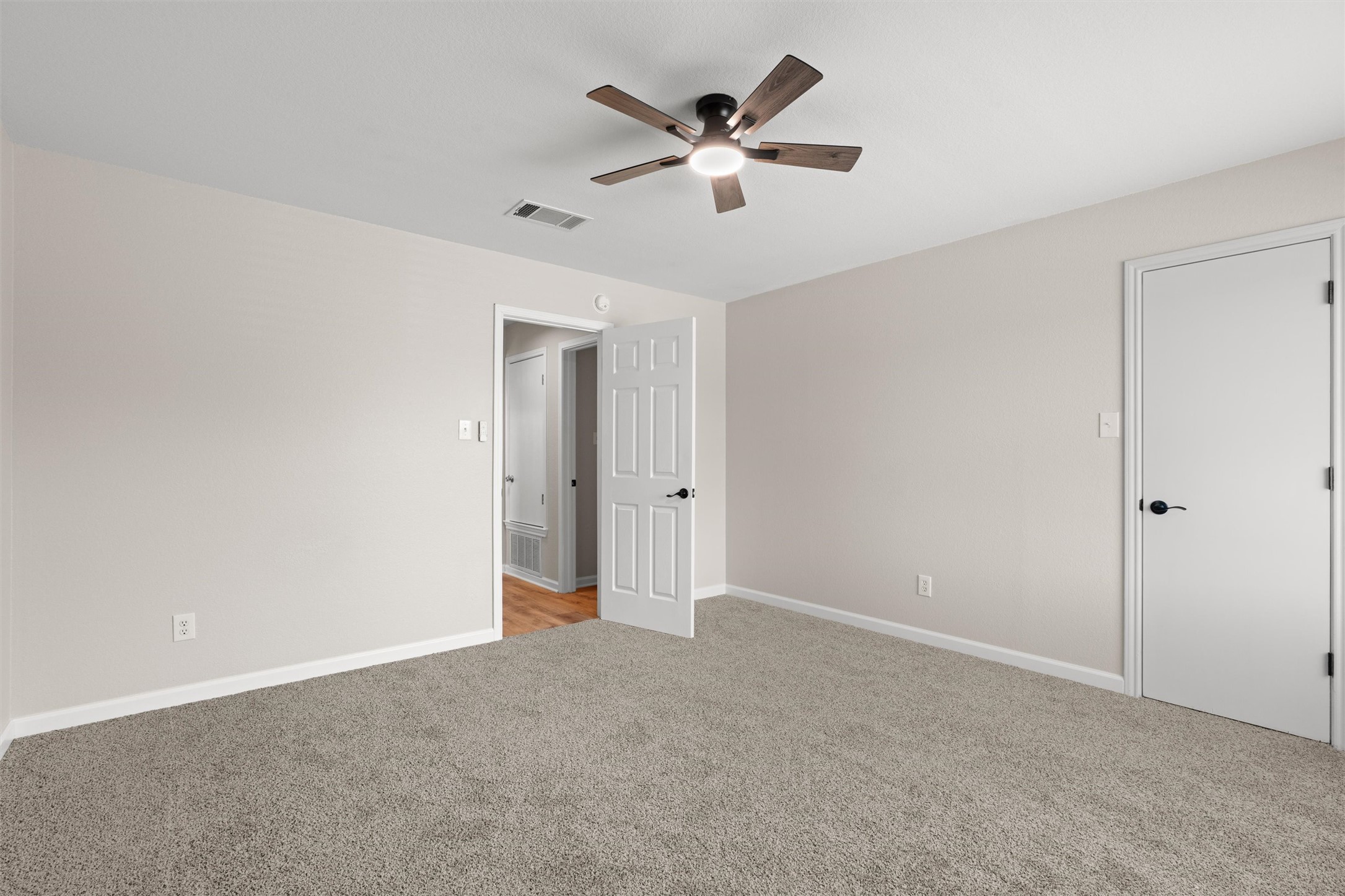 724 Lavaca Loop Elgin, TX 78621 - Photo 30 of 40 Soft carpeting pairs with neutral walls in this versatile bedroom space.
