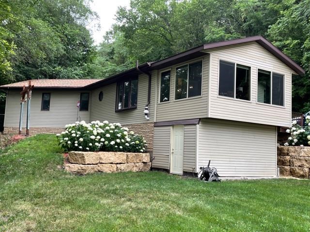 3923 Scenic Bluff Road Thomson, IL 61285 - Photo 1 of 28 a front view of a house with a garden