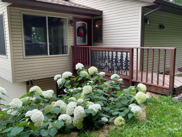 3923 Scenic Bluff Road Thomson, IL 61285 - Photo 2 of 28 a bunch of flowers in front of house