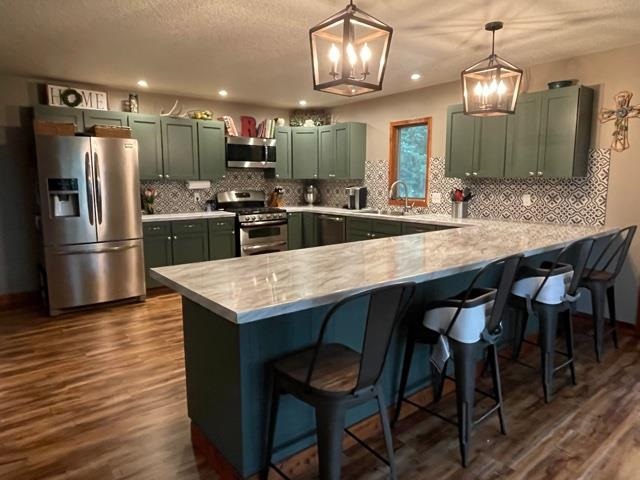 3923 Scenic Bluff Road Thomson, IL 61285 - Photo 9 of 28 a kitchen with granite countertop a table chairs stove refrigerator and microwave
