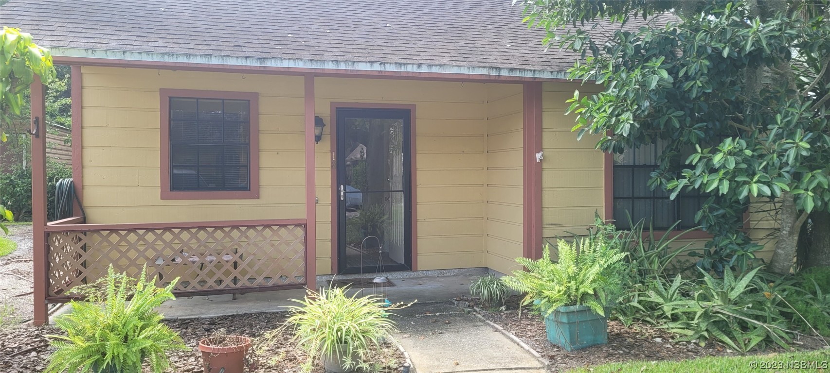 232 North Ridgewood Avenue, Unit D18 Edgewater, FL 32132 - Photo 1 of 1 a front view of a house with a garden