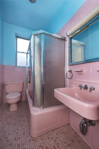 a bathroom with a sink toilet and mirror