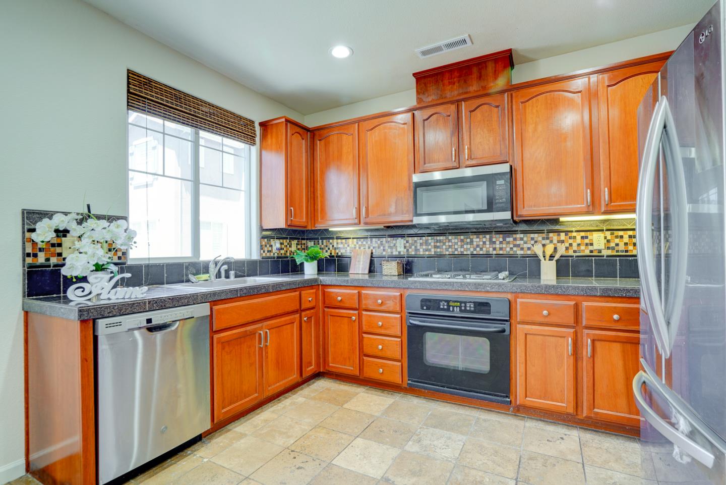 3546 Sequoia Common Fremont, CA 94536 - Photo 6 of 25 a kitchen with stainless steel appliances granite countertop a stove sink and cabinets
