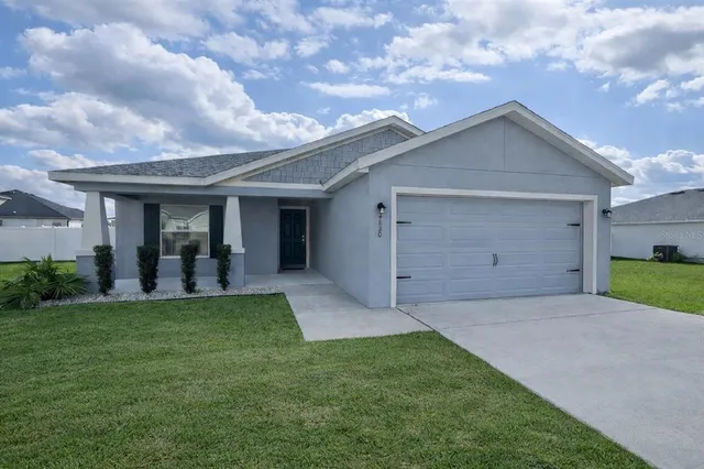 a view of a house with a yard and garage