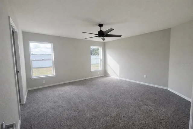 a view of a livingroom with a ceiling fan and window