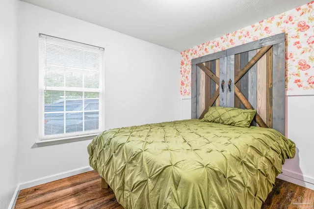 a bed sitting in a bedroom next to a window