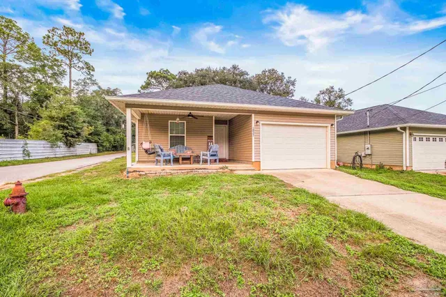 a view of a house with a backyard