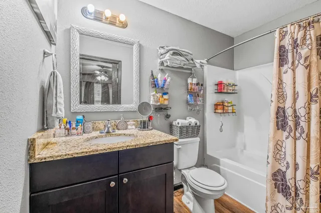 a bathroom with a sink vanity mirror and toilet