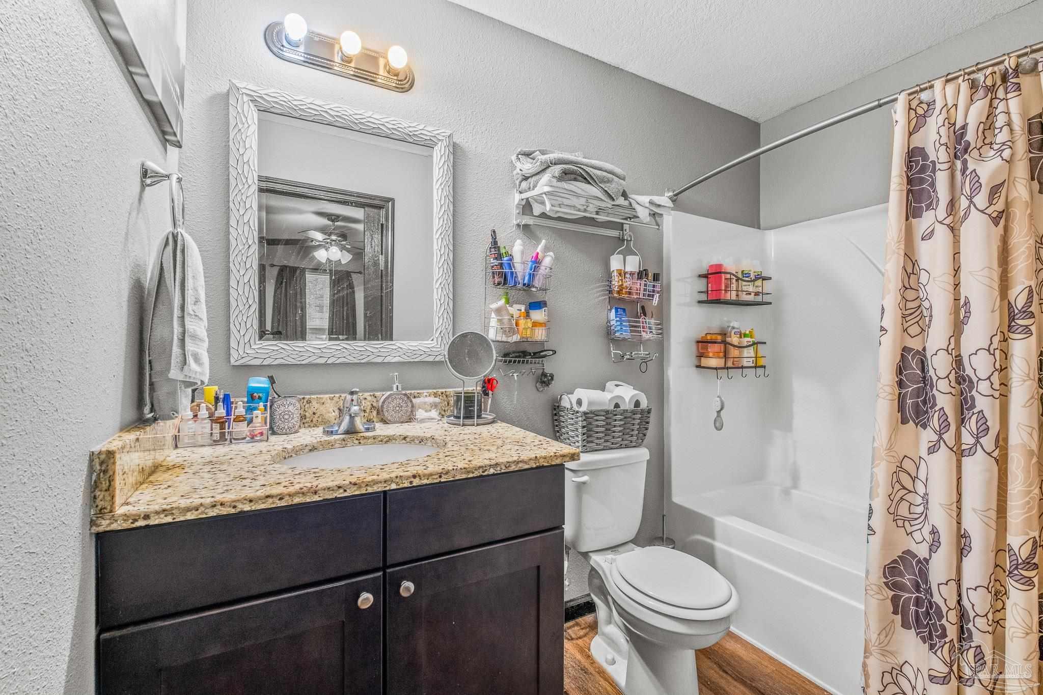 1827 Gainer Avenue Baker, FL 32531 - Photo 24 of 30 a bathroom with a sink vanity mirror and toilet