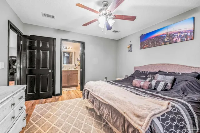 a bedroom with a bed and wooden floor
